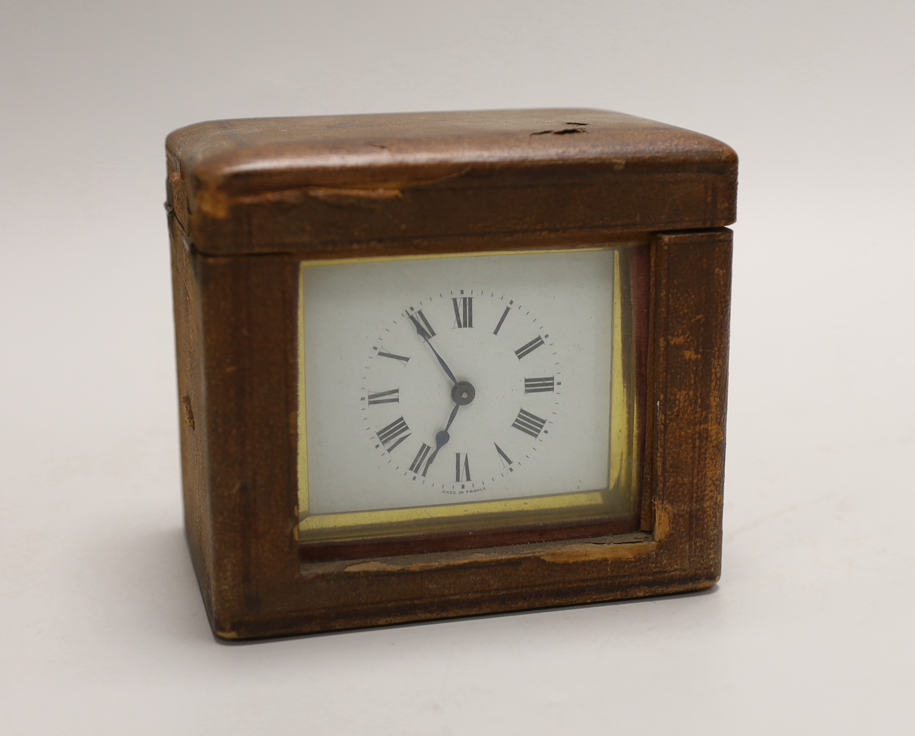 A small French brass carriage clock, 11cm, in leather case